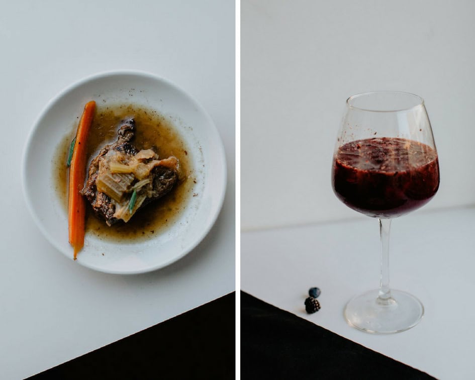 Gourmet dish with fresh ingredients and a glass of red wine for summer dining.