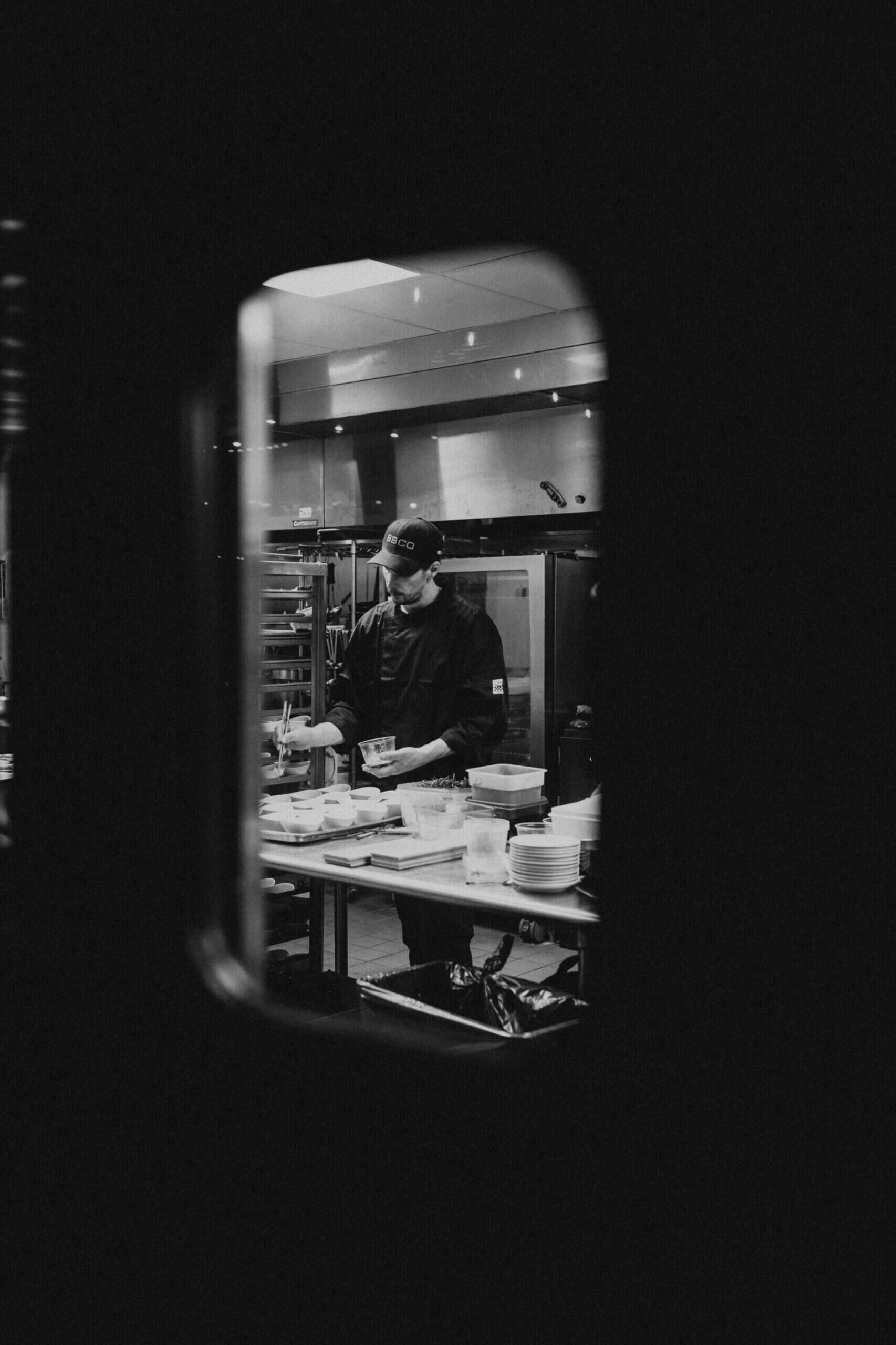 Chef preparing food in a professional kitchen at SKY Armory.