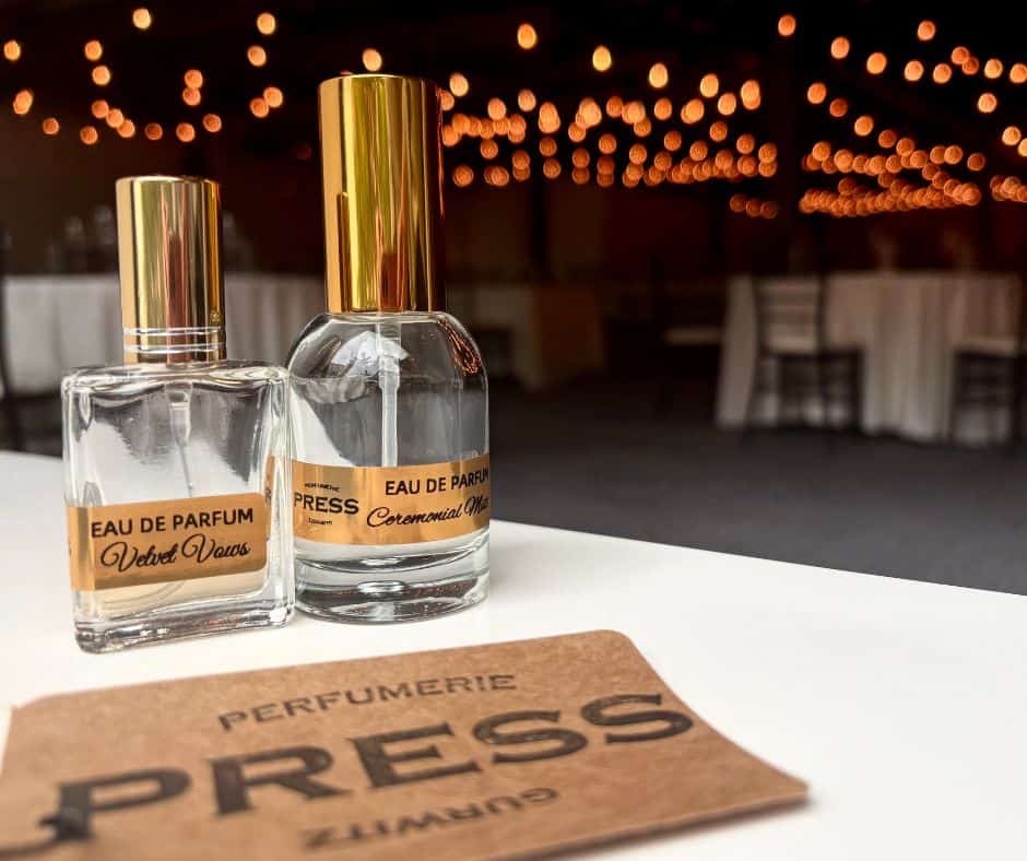 Two perfume bottles with gold caps on a table at SKY Armory event.
