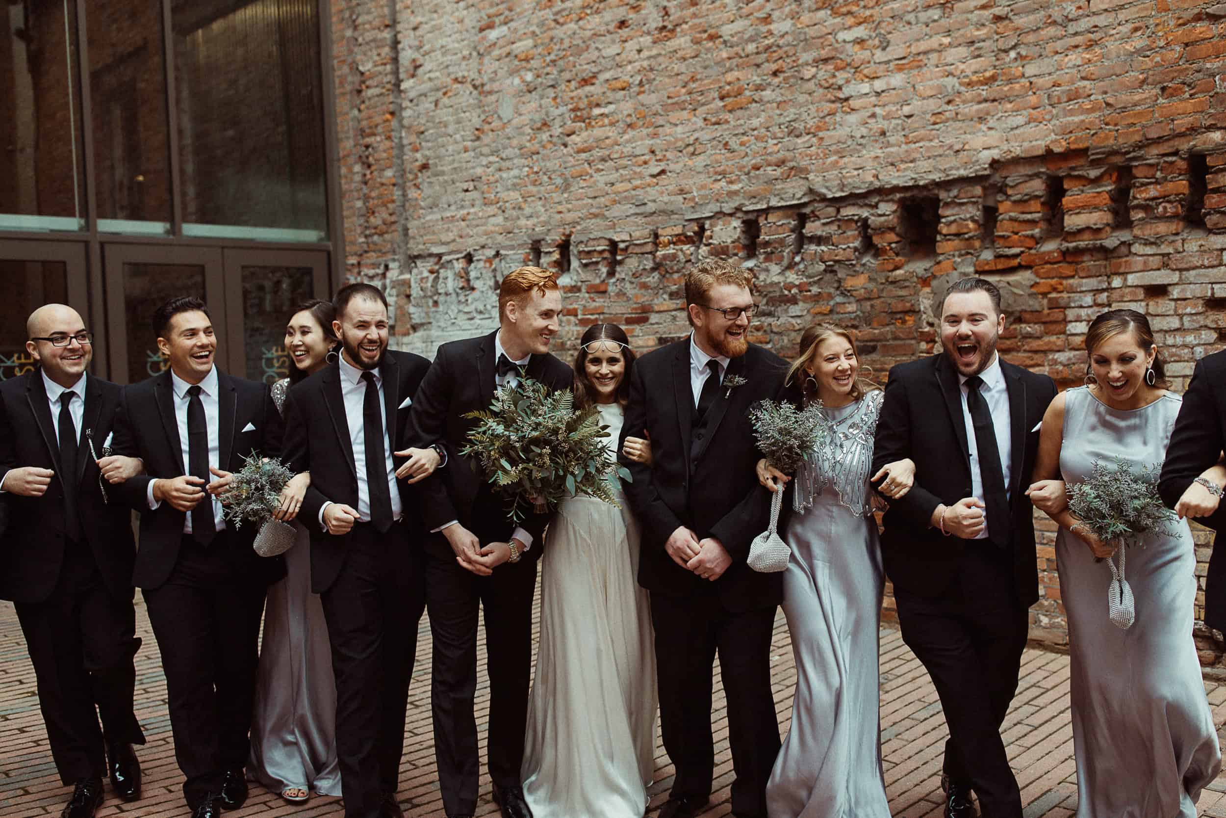 Group of wedding guests in formal attire at Sky Armory venue.