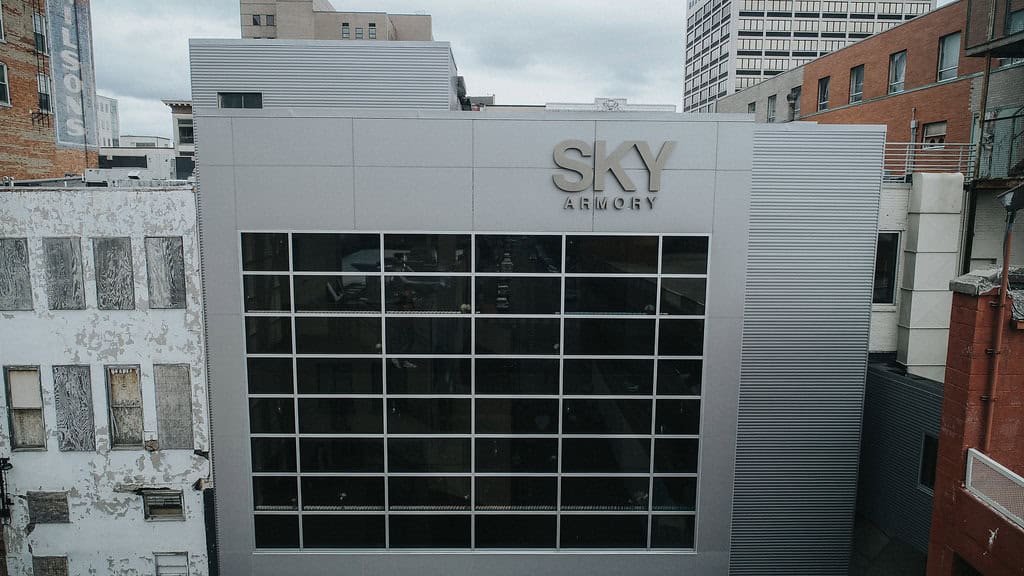 Modern SKY Armory building with glass facade in an urban setting.