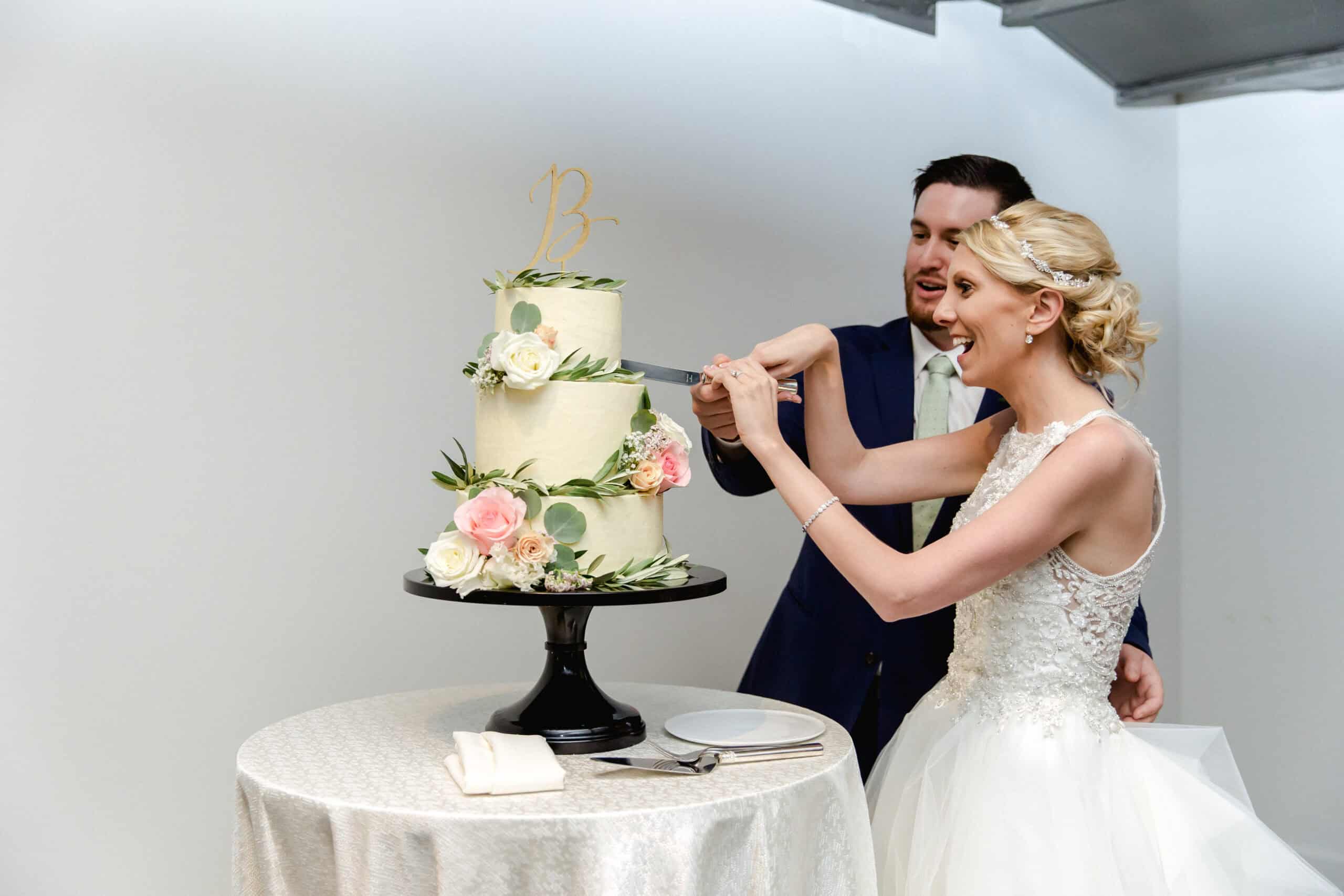 Bride and groom cutting wedding cake at SKY Armory event.