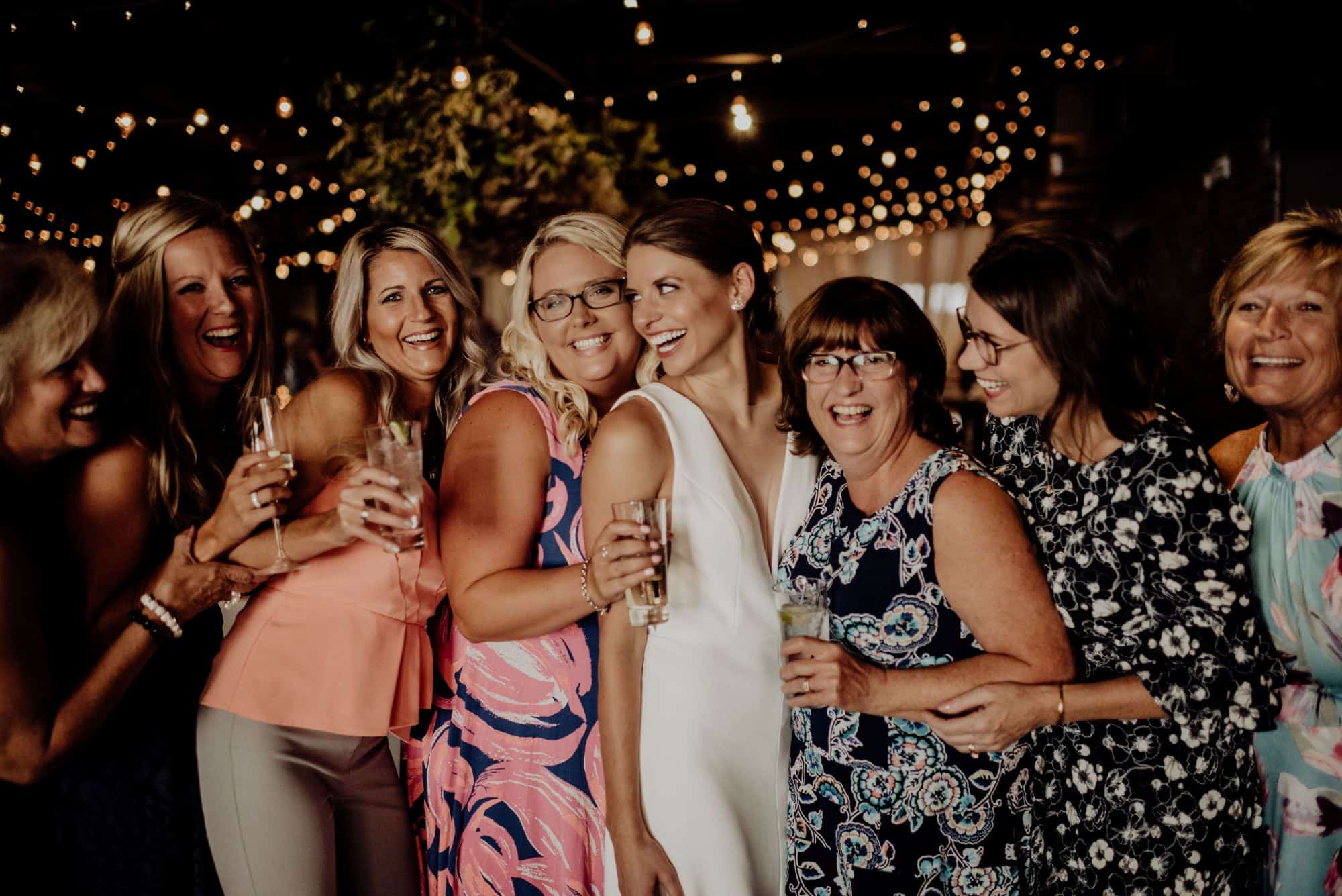 Group of women celebrating at SKY Armory with drinks and joyful expressions.