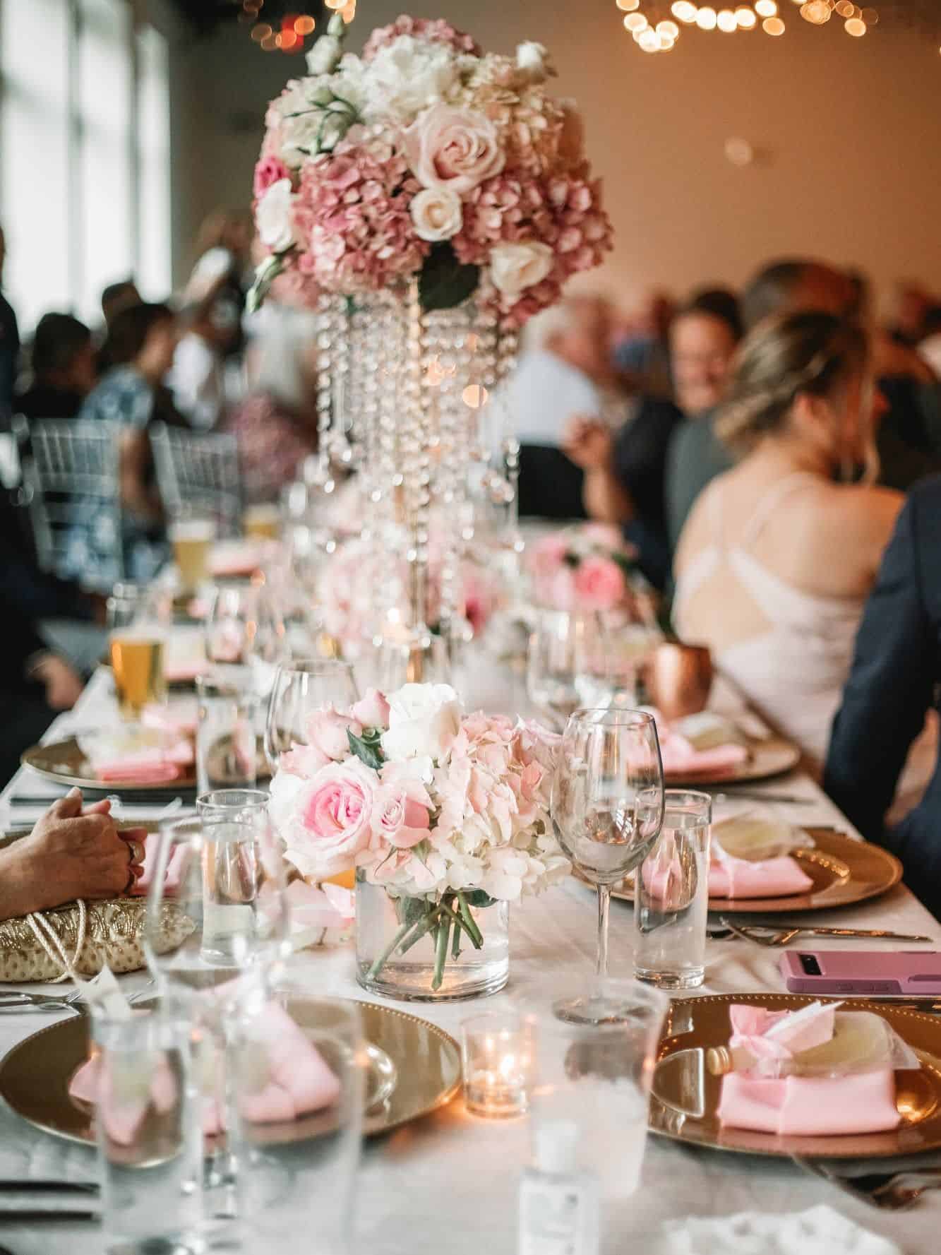 Beautiful wedding reception table with floral centerpieces and elegant decor.
