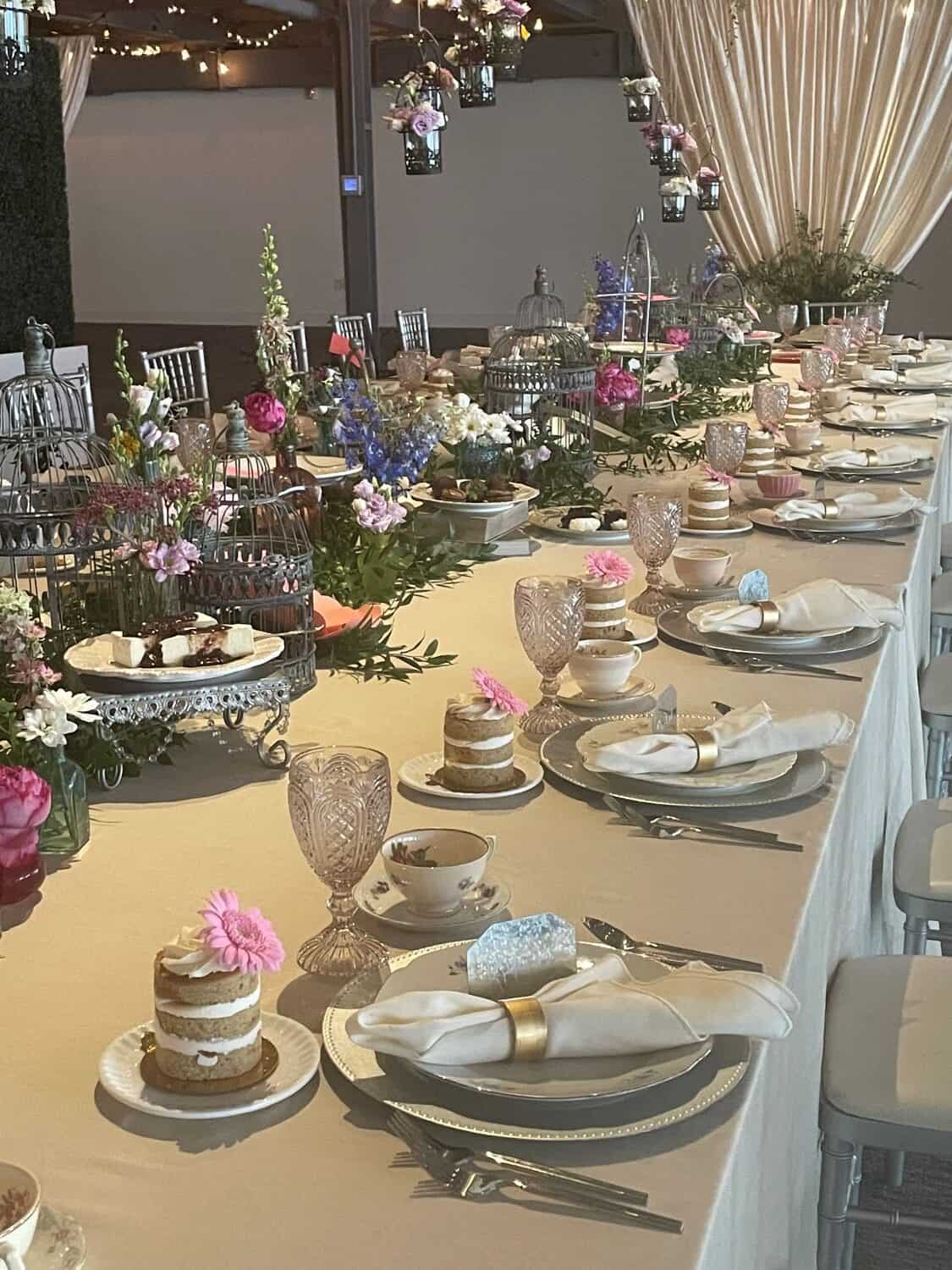 Decorated event table with floral arrangements, fine china, and elegant glassware at SKY Armory.