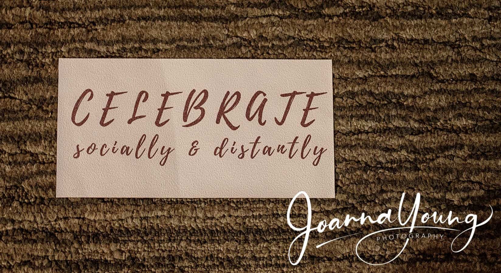 Celebrating socially and distantly with a handwritten note on a wooden surface.