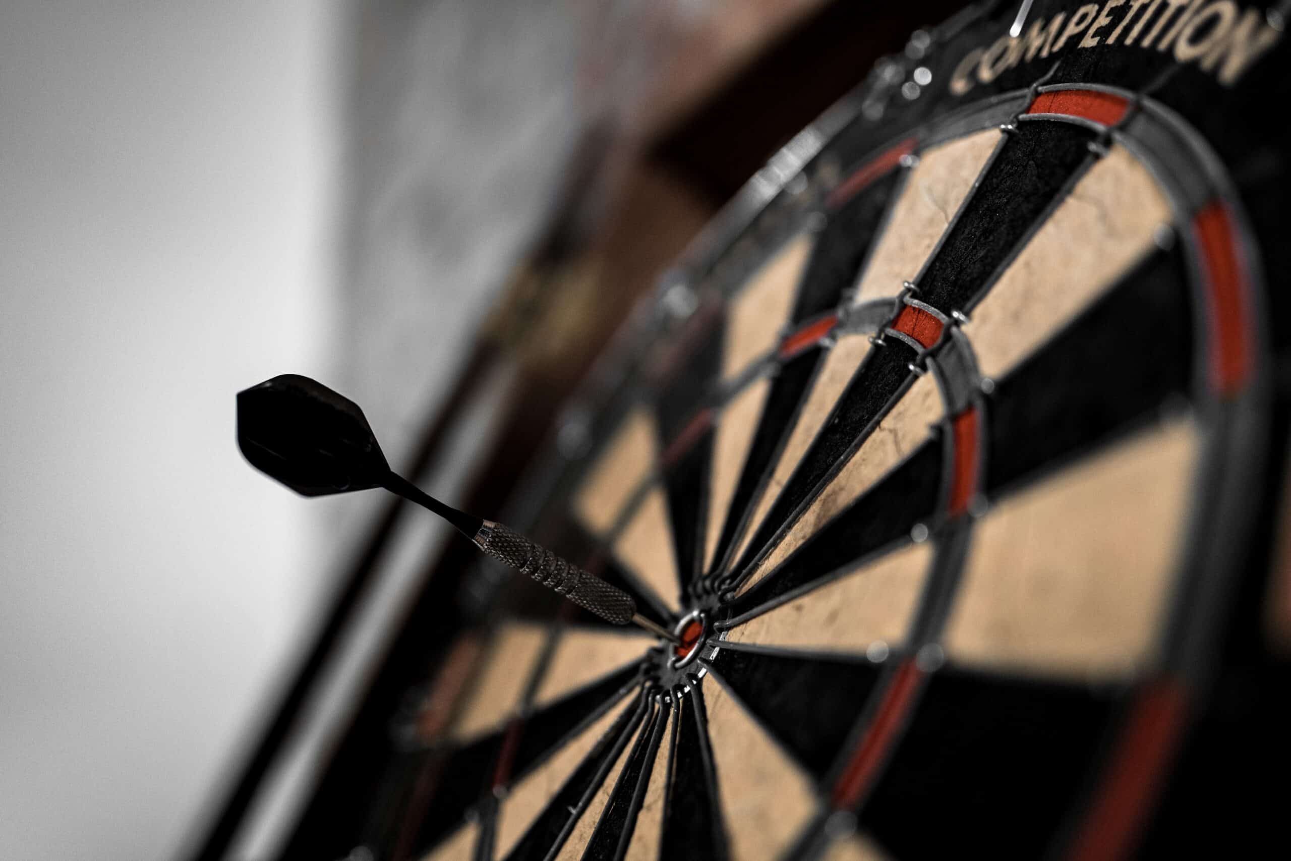 Close-up of a dart hitting the bullseye on a SKY Armory dartboard.
